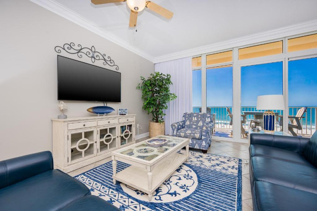 a living room with a flat screen tv and a couch at Phoenix Orange Beach II 603 condo in Orange Beach