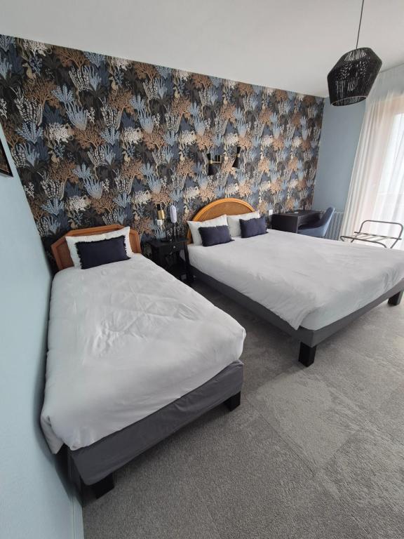 Postel nebo postele na pokoji v ubytování Hôtel l'Albatros