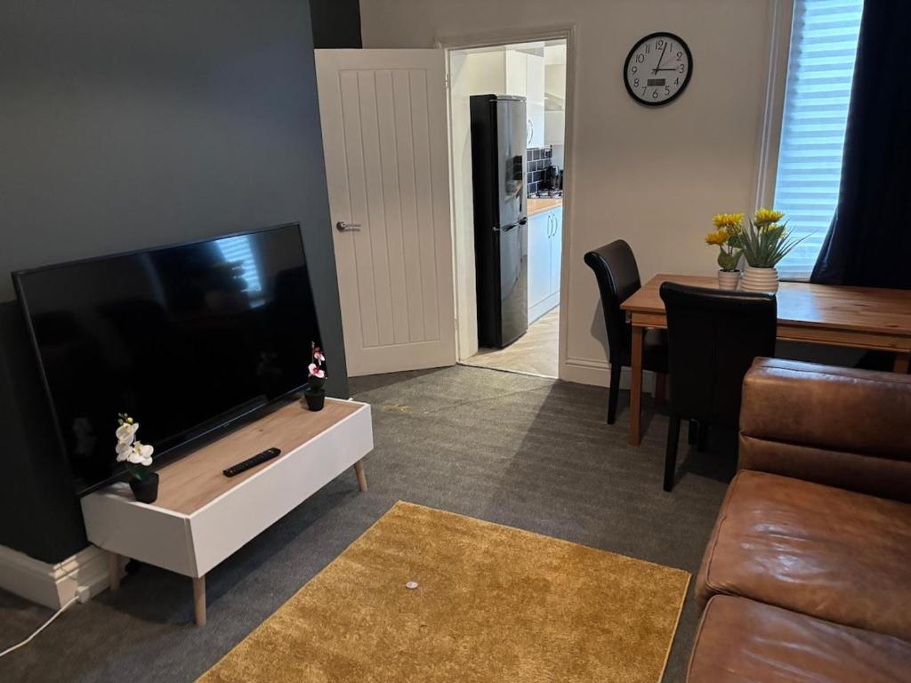 a living room with a large flat screen tv at Imperial Suite, Free Parking in Blythe