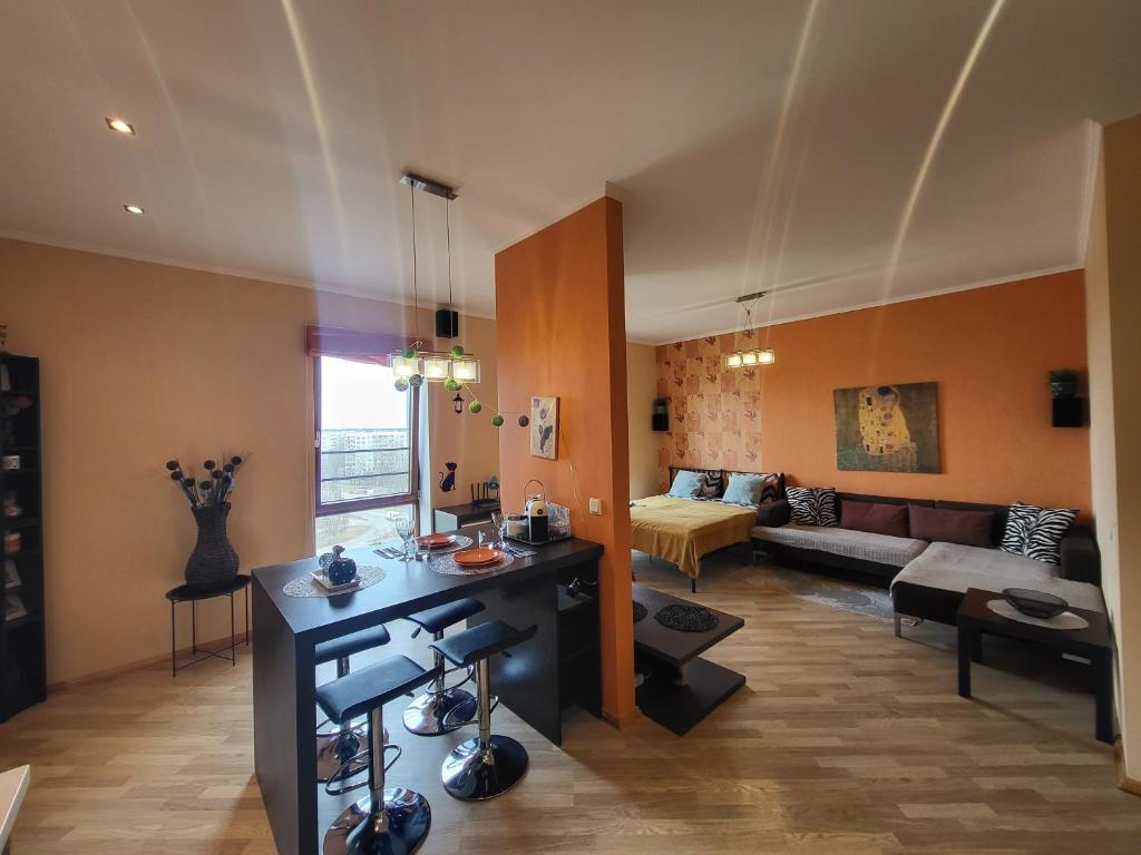 a living room with a couch and a table at Solaris Studio Apartments in Rīga