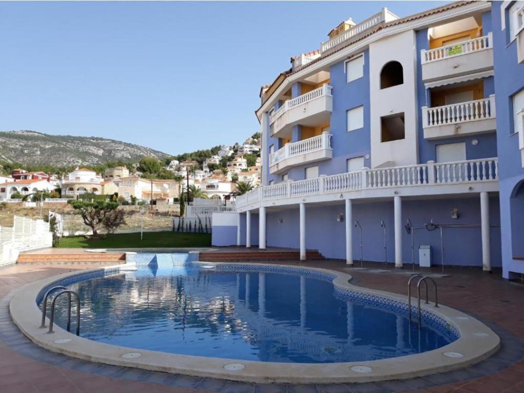 a swimming pool in front of a building at Marcotin Piscina playa y montaña in Alcossebre