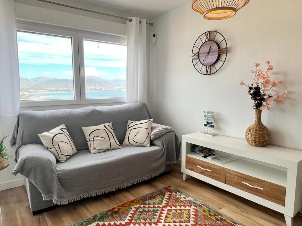 a living room with a couch and a window at Alta Vista! in Puerto de Mazarrón