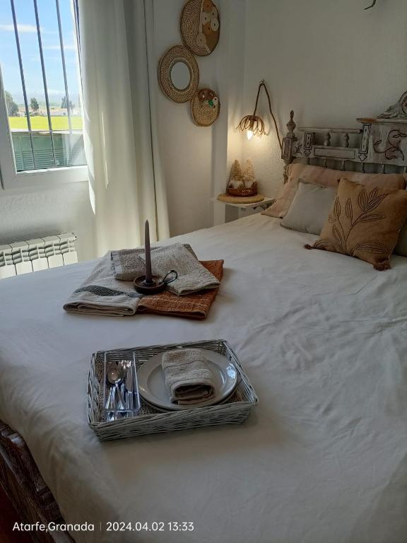 a tray with a candle on top of a bed at CasaElaqui in Atarfe