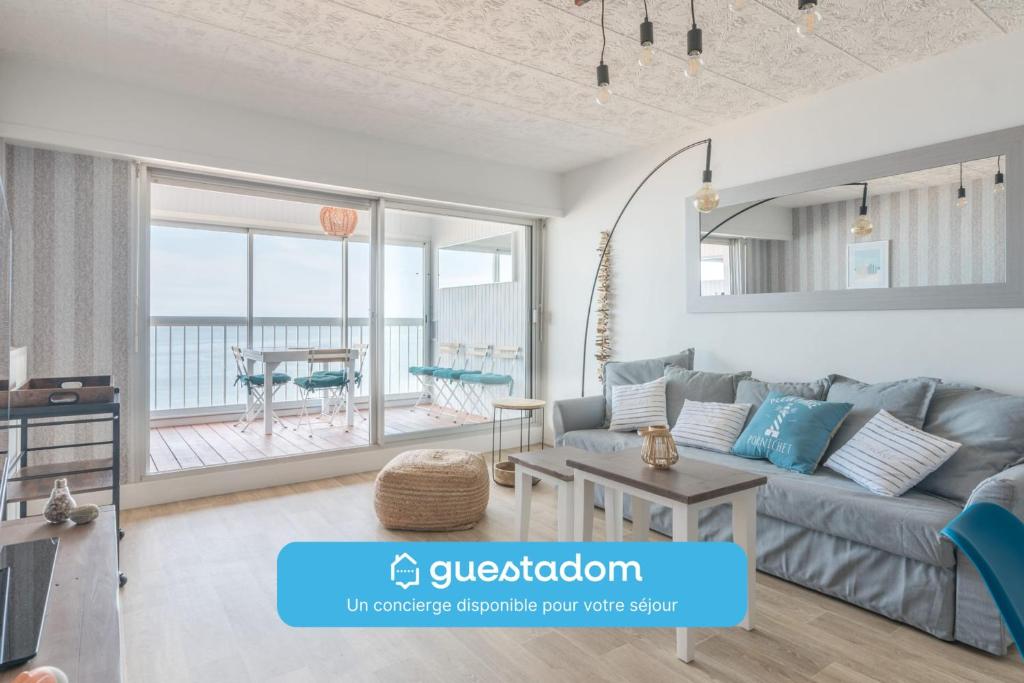 a living room with a couch and a table at LE PANORAMIQUE - Face mer - Wifi in Pornichet