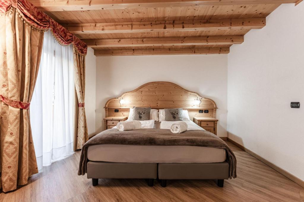 Postel nebo postele na pokoji v ubytování Hotel Sasso Rosso