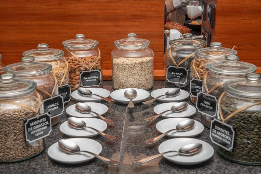 Glass jars of grains, seeds, and dried ingredients line a self-service buffet station.