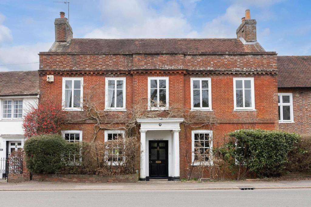 an old red brick house with a black door at Country Retreat - Sleeps 14 - Large Garden in Westbourne