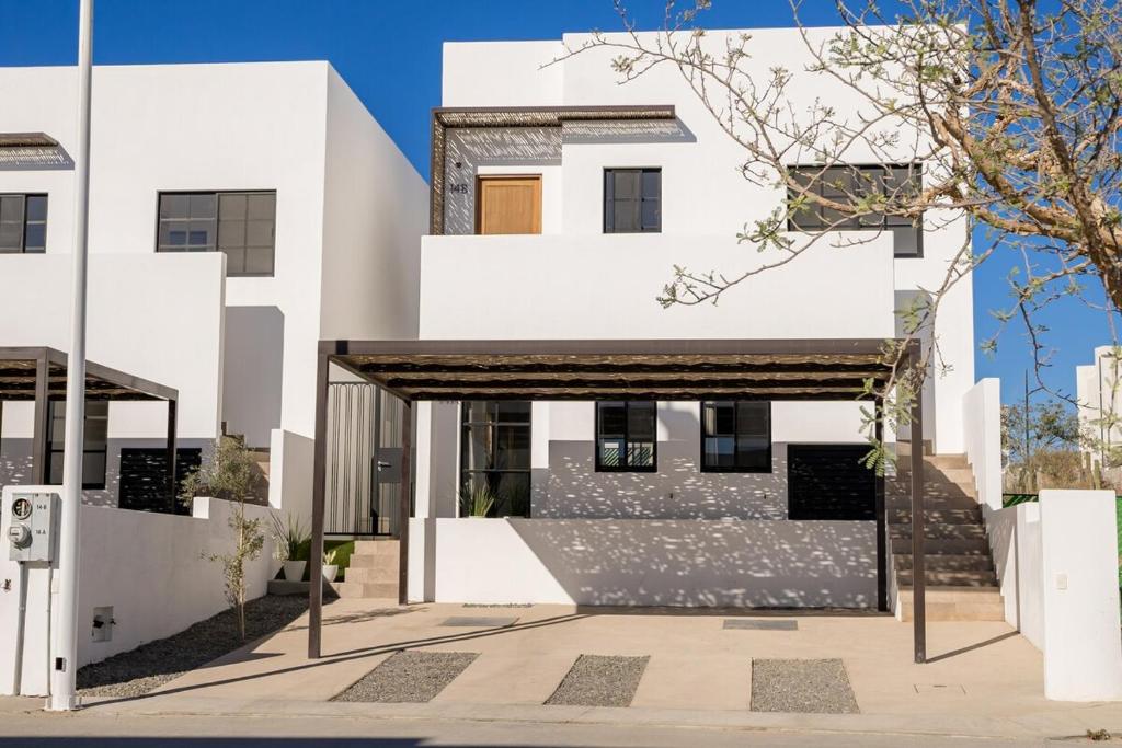 a white house with a black and white facade at Cabo San Lucas House, 2Bedroom, 2Bathrooms,Pool, Rooftop views in El Pueblito