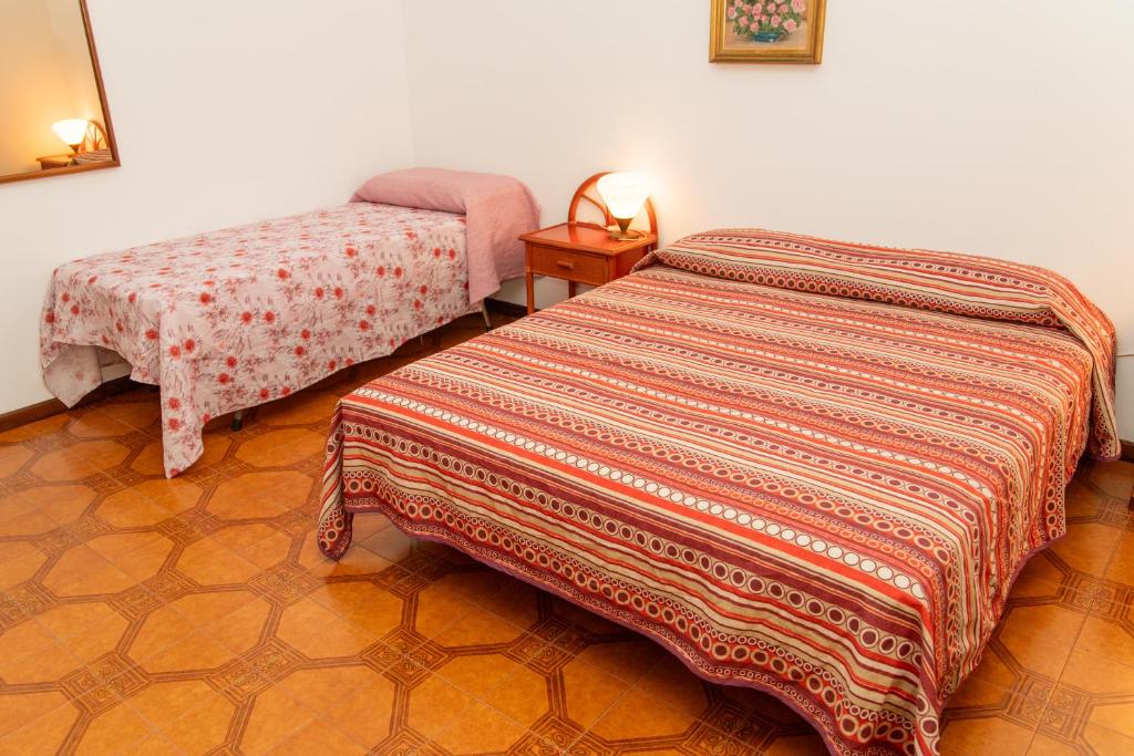 Postel nebo postele na pokoji v ubytování Cinzia House