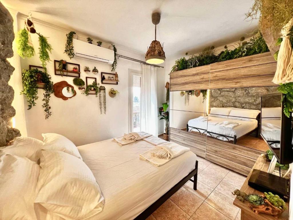 a bedroom with two beds and plants on the wall at Jungle In The City ,Corfu - Kanoni in Corfu Town