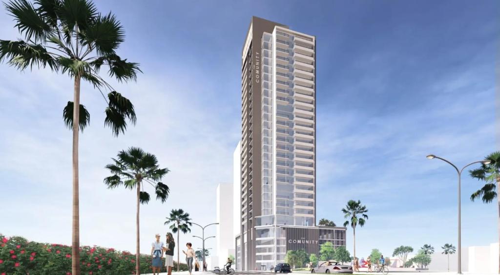 a rendering of a tall building with palm trees at The Community Jumeirah Village in Dubai