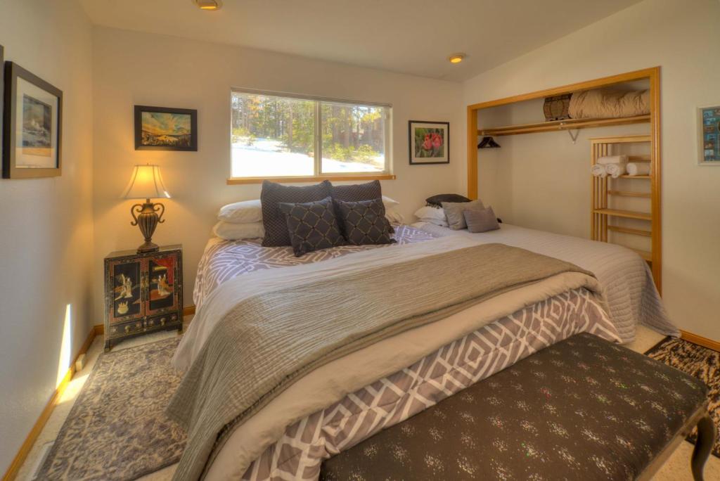 a bedroom with a large bed and a window at Enviable Lake & Mountain Views Wth Waterfall in South Lake Tahoe