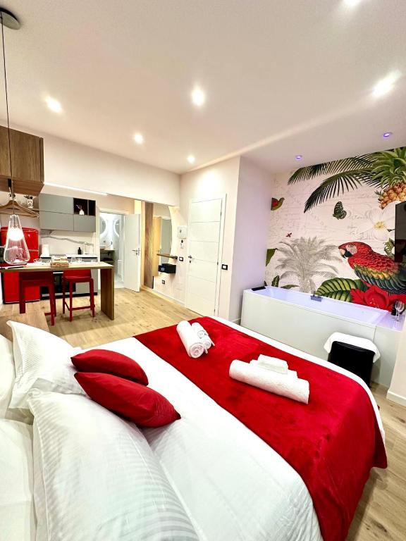 a bedroom with a large bed with red and white pillows at Luxury Fire Home - Catania in Catania