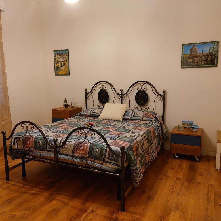 a bedroom with a bed with a quilt on it at Camera "La Margherita" in Pistoia