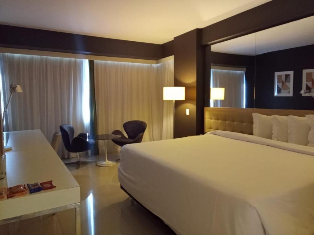 Cama ou camas em um quarto em eSuites Savassi Toscanini