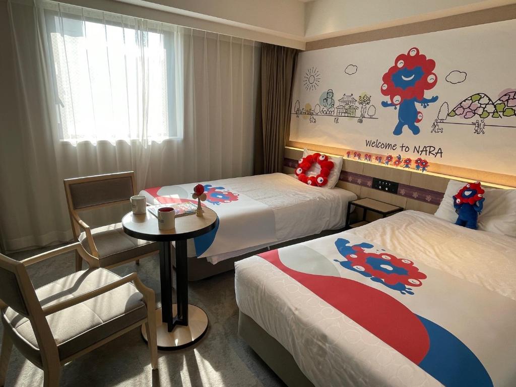 a hotel room with two beds and a table and chairs at Henn na Hotel Premier Nara in Nara