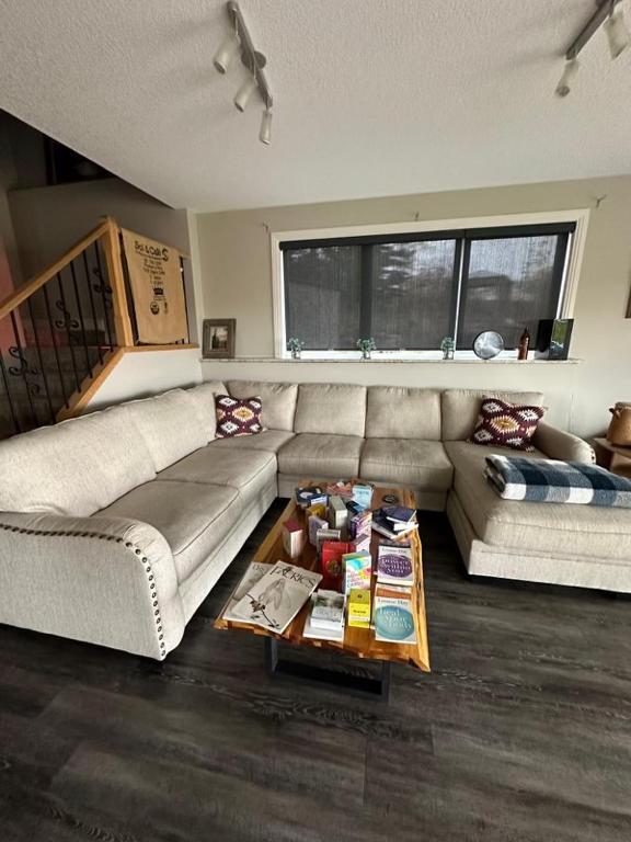 a living room with a couch and a coffee table at Misty Ridge Retreat B&B in Foothills
