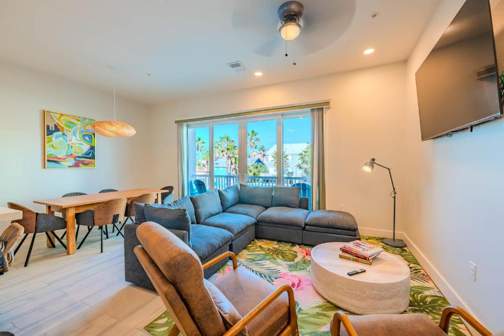 a living room with a blue couch and a table at Indigo Sea Escape in South Padre Island