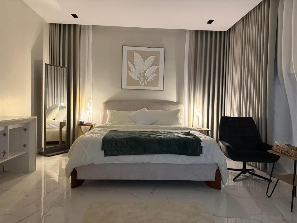 a bedroom with a bed and a desk and a chair at Rfaa Suites in Medina