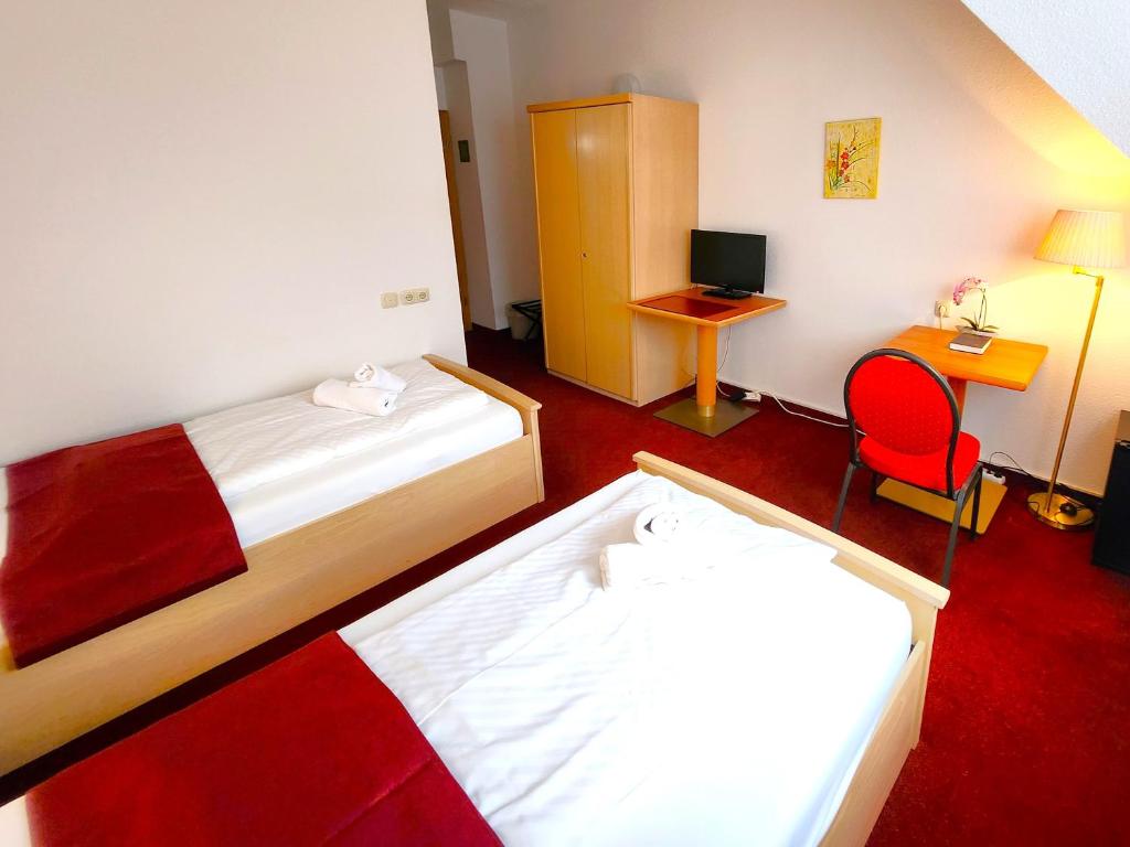 Postel nebo postele na pokoji v ubytování Pension Blümchen am Kiesgrube