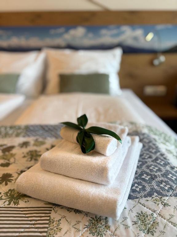 a pile of towels sitting on top of a bed at Apartment Helena in Bad Goisern