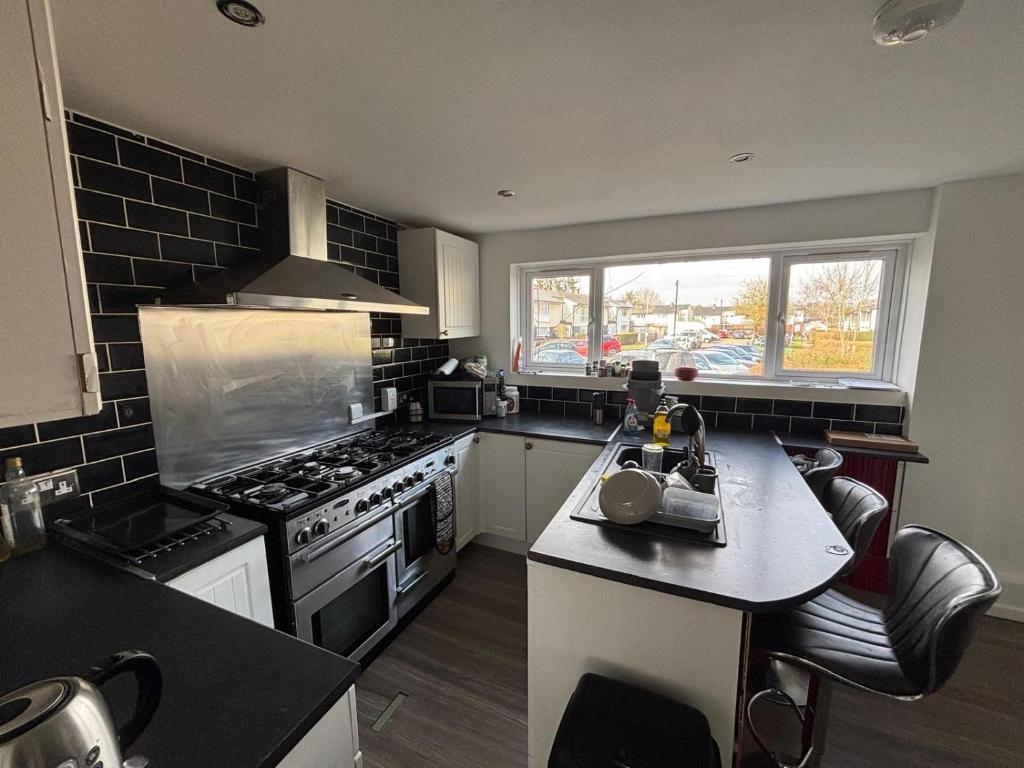 a kitchen with a stove and a counter top at Shared Home - Self Check-In - Resident Cat in Hatfield
