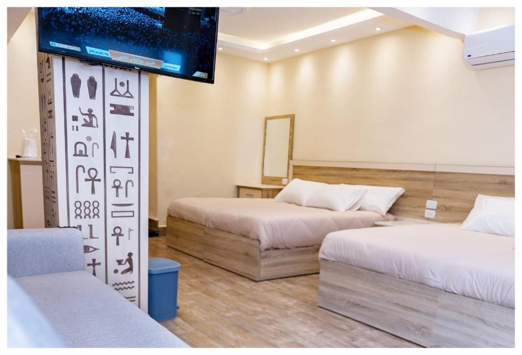 Postel nebo postele na pokoji v ubytování Hasan Pyramids Hotel