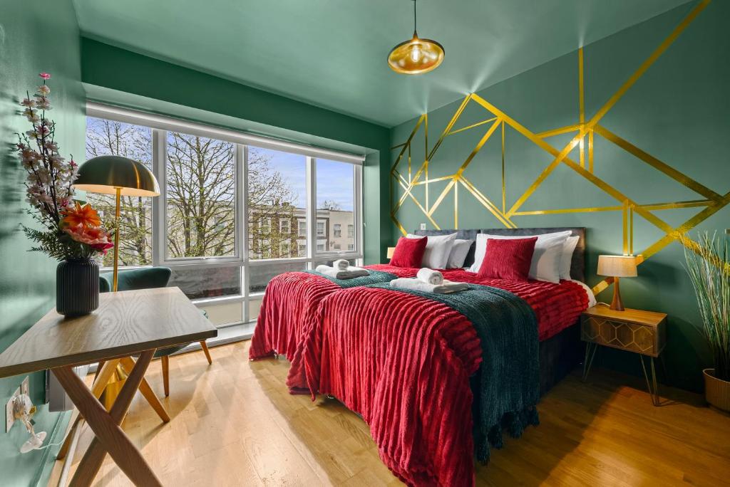 a bedroom with a large bed and a window at Dapper Suite in bustling Holloway, Islington by Gold Stays in London