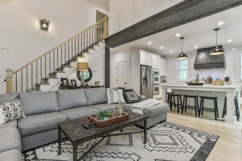 a living room with a gray couch and a table at Robins Nest at Big Canoe - Big Canoe, GA - Enjoy Peaceful Forest Views, Rack Up a Game of Pool, and Enjoy Game Nights in the Gam in Jasper