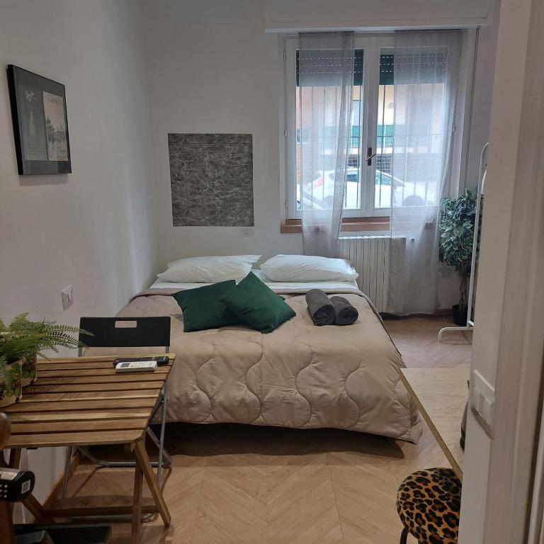 a bedroom with a bed and a table with a desk at Doberdó in Milan