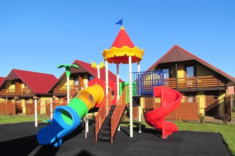a playground in front of a house at Terraced House in Rewal near Baltic Sea Beach in Rewal