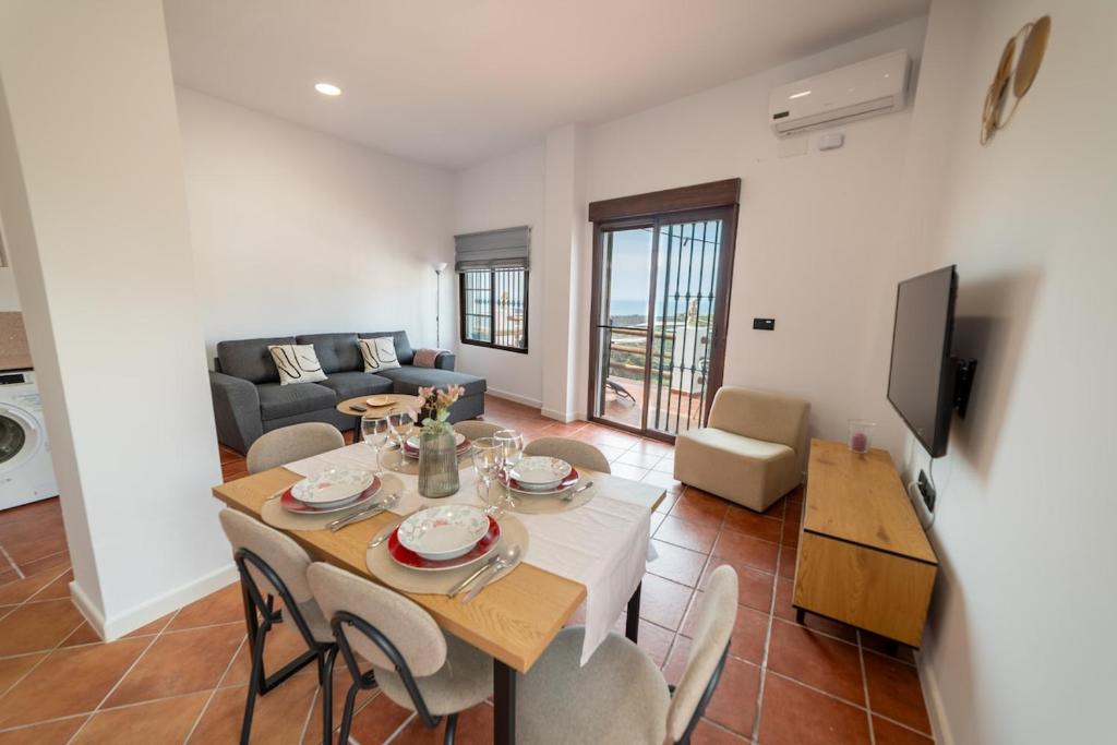 a living room with a table and chairs and a couch at Apartamento Monte Mar 2 in Haza del Trigo