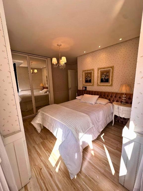 グラマドにあるApto na Borges de Medeirosの大きなベッドと鏡のある寝室