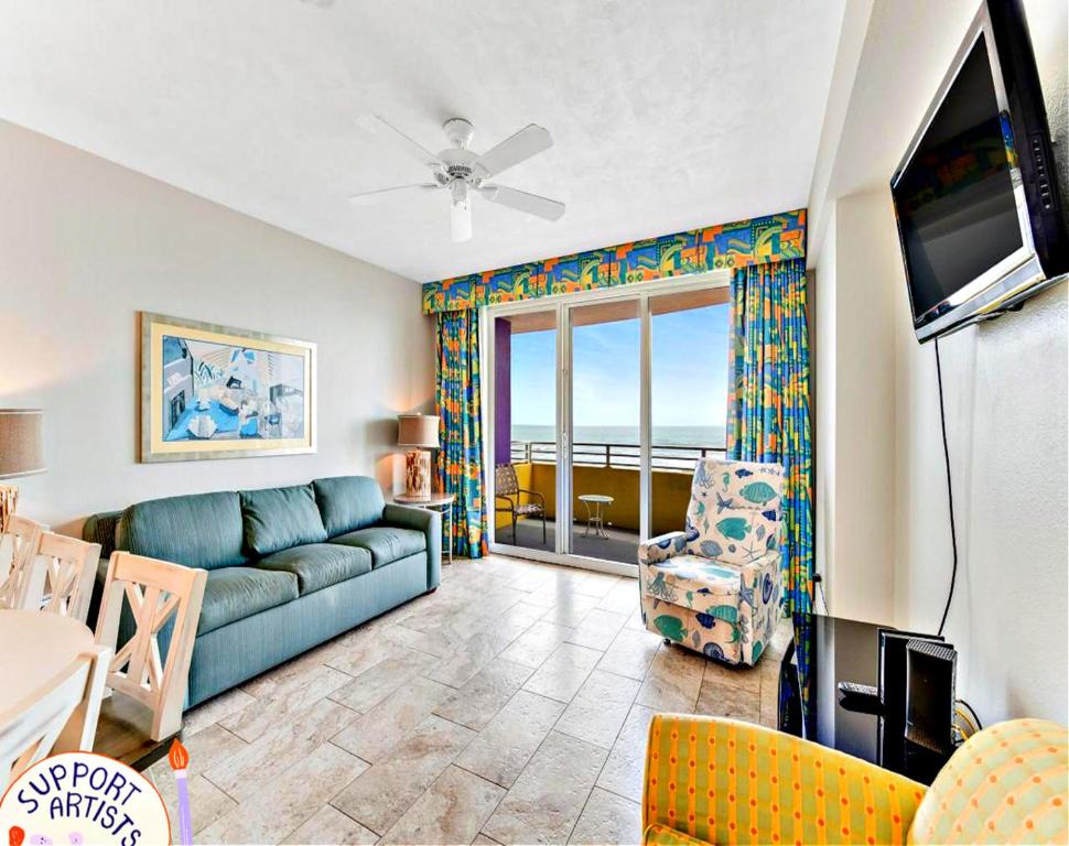a living room with a couch and a television at Highly Desired 6th Floor 1 BR Oceanfront - There Is Only One Ocean Walk Resort 606 in Daytona Beach