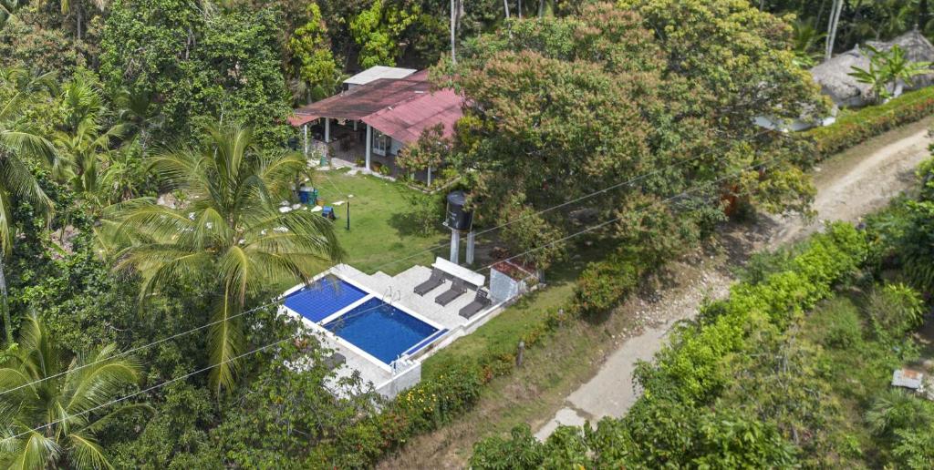 an aerial view of a house with a swimming pool at Hostal Casa del Rio in Guachaca