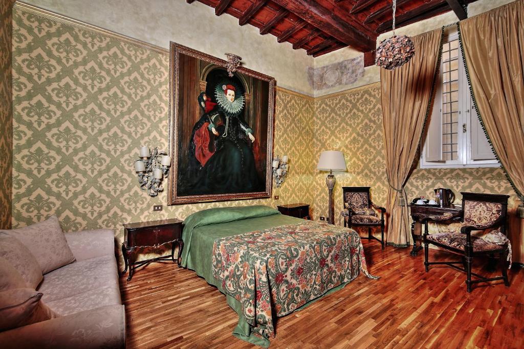 a bedroom with a painting of a woman on the wall at Antica Dimora dell'Orso in Rome