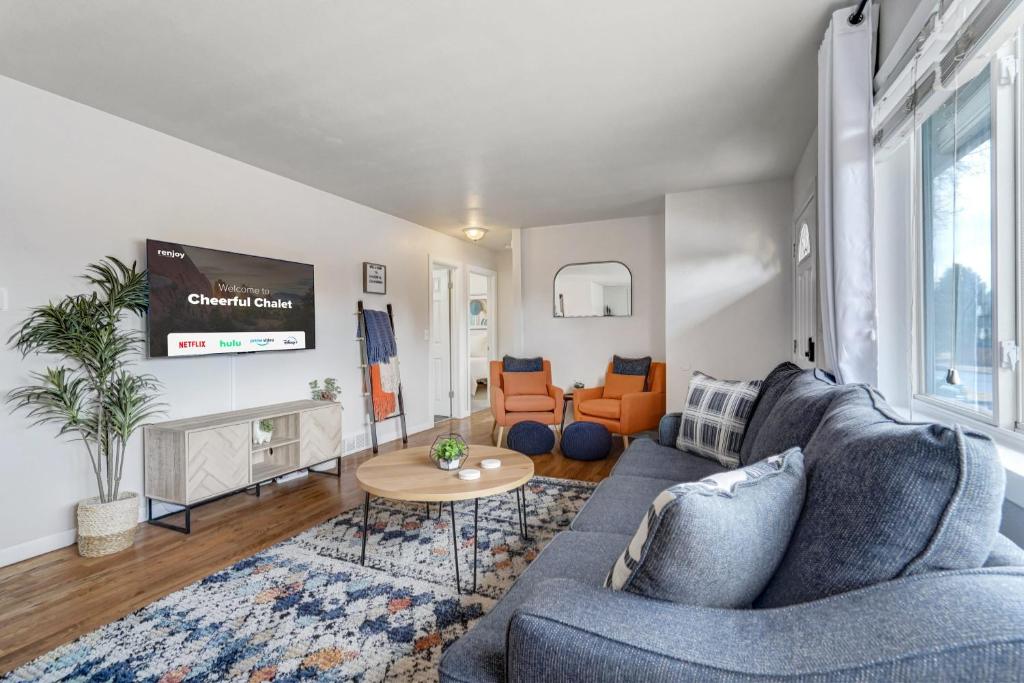 a living room with a couch and a table at Cheerful Chalet Centrally Located w BBQ Pit in Colorado Springs