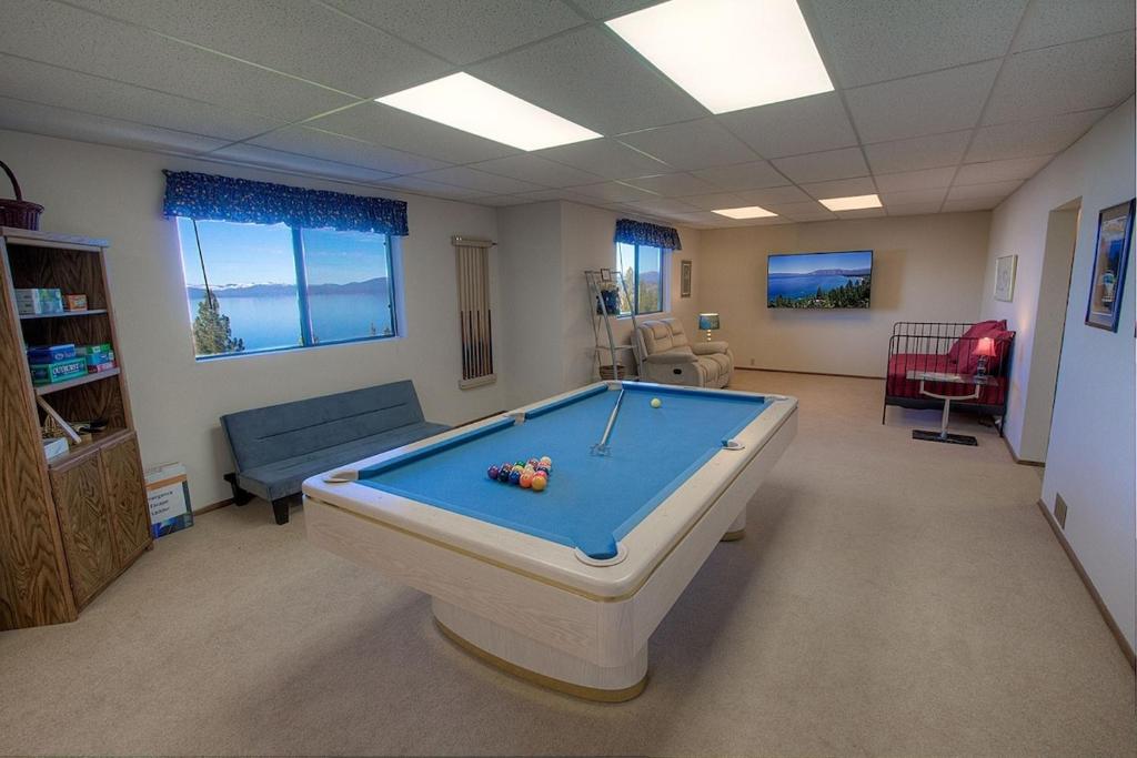 a living room with a pool table in it at Lake View Glen home in Lincoln Park