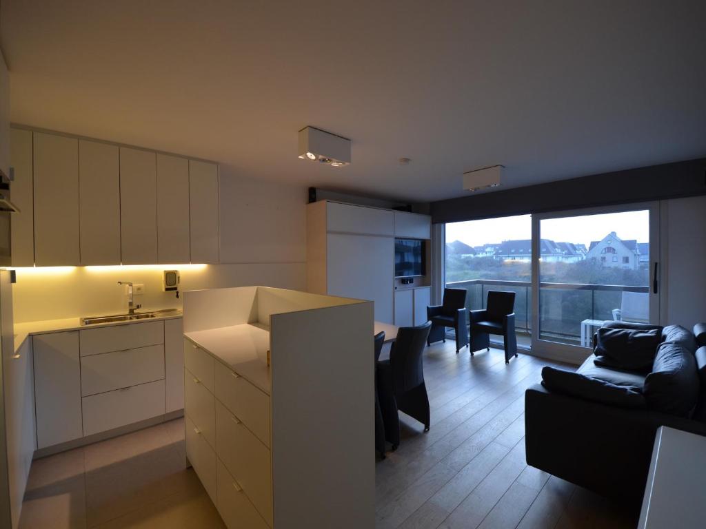 a kitchen and living room with a couch and a table at Studio in Belgium near Beach & Dunes in Oostduinkerke