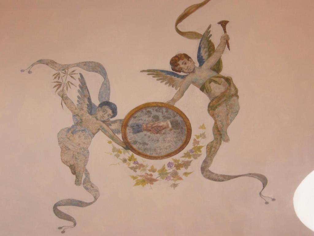 a painting of angels on a wall with a mirror at Albergo 'La Vigna' in Procida