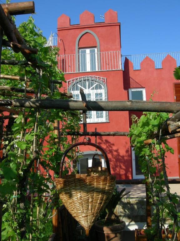 a basket hanging from a pole in front of a building at Albergo 'La Vigna' in Procida