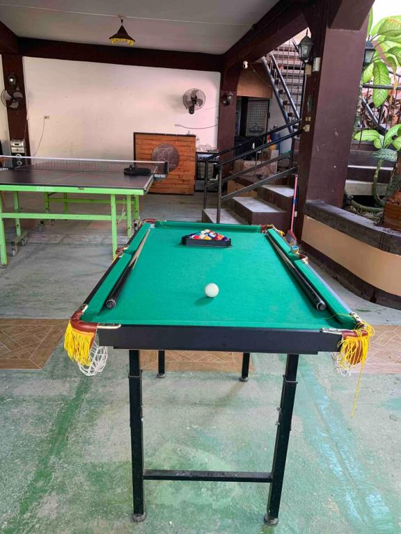 a pool table with a ball on top of it at G-Bay Farm Village in Malolos