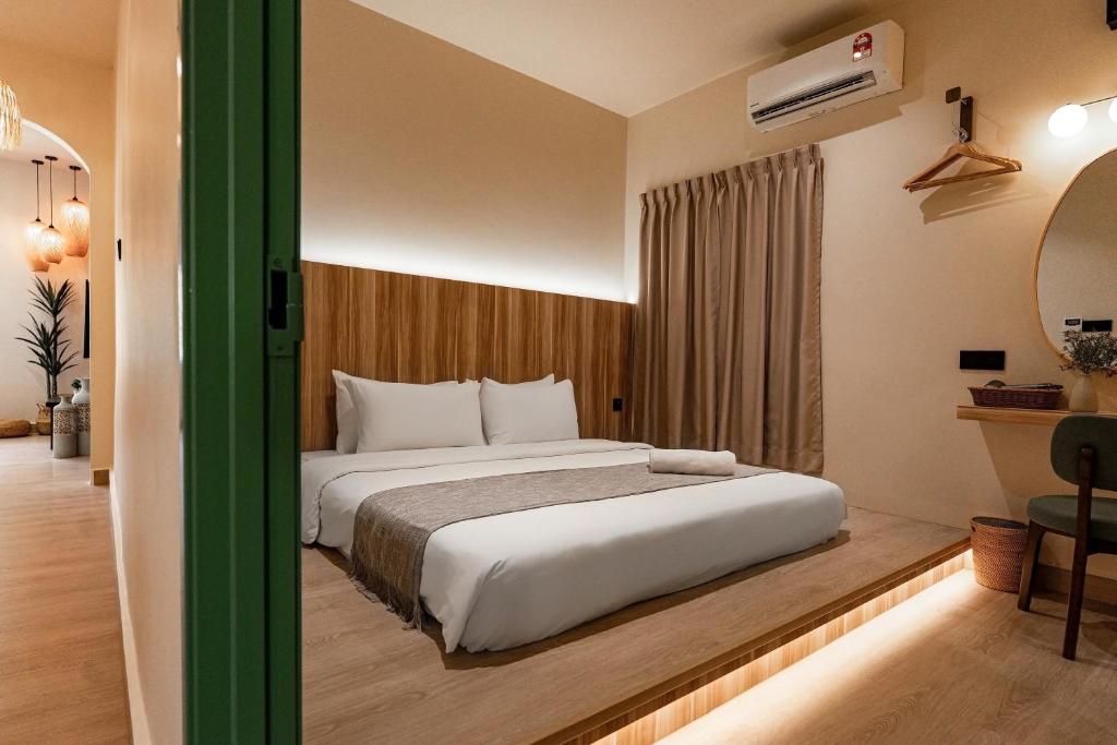 a bedroom with a large bed in a room at Laman Villa Langkawi in Pantai Cenang