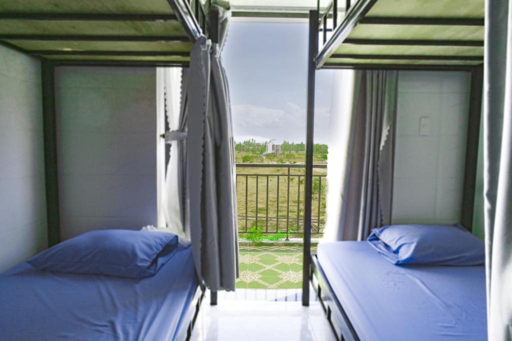 Postel nebo postele na pokoji v ubytování Nalani Homestay & Hostel Hoi An
