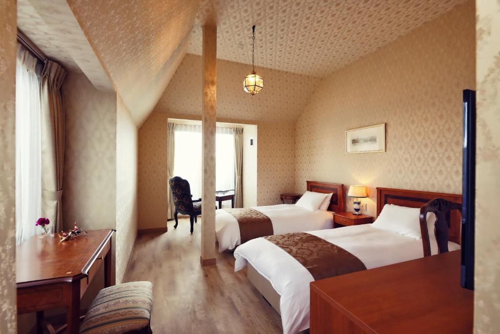 Postel nebo postele na pokoji v ubytování Auberge フレンチの森