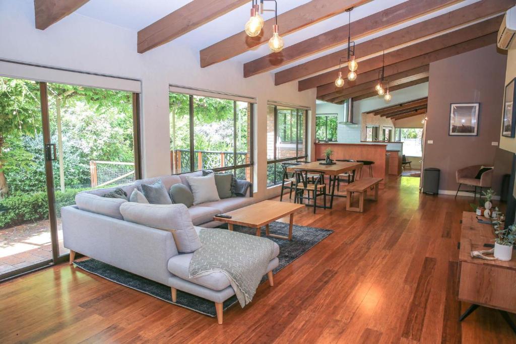 a living room with a couch and a table at Haus On Houghs in Bright