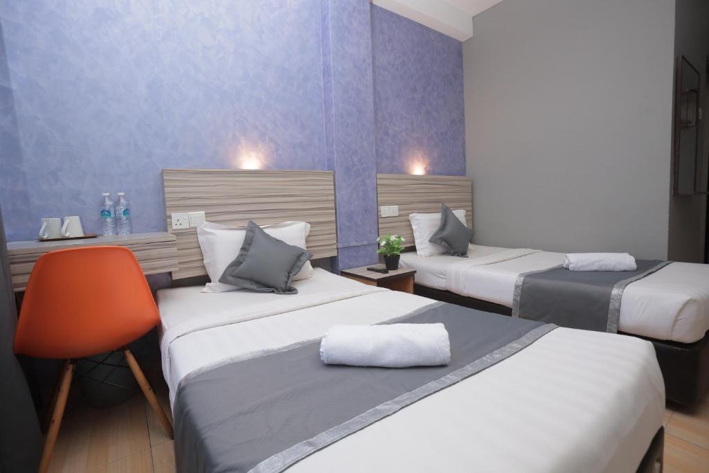 Postel nebo postele na pokoji v ubytování DJ Citi Inn Premier