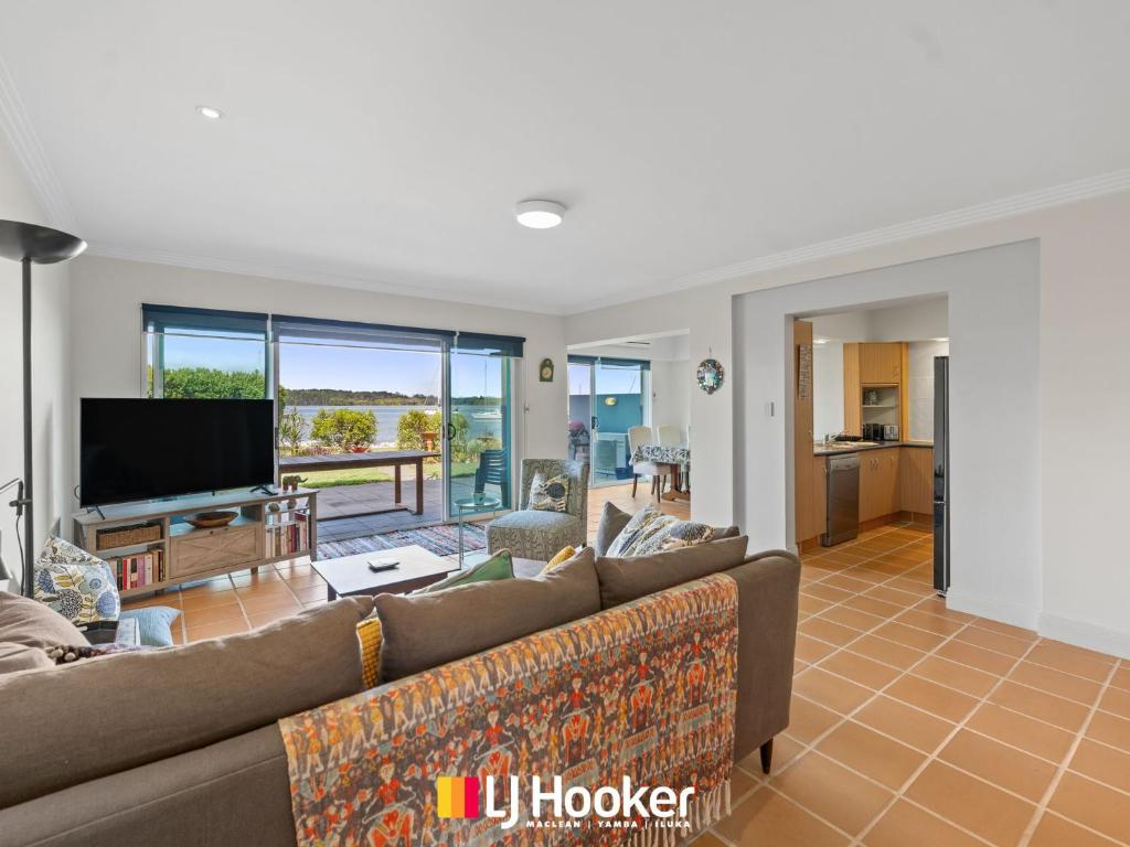 a living room with a couch and a flat screen tv at Riverview Apartment 1.2 in Iluka