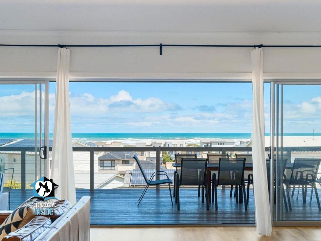 a dining room with a view of the ocean at Ultimate in Middleton Coastal Style with Views Sleeps 10 in Middleton