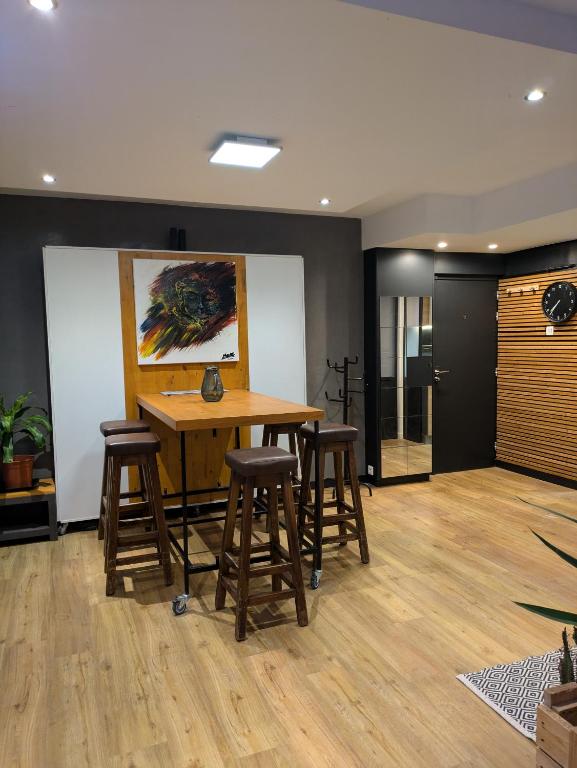 a dining room with a table and stools at La promenade in Rennes